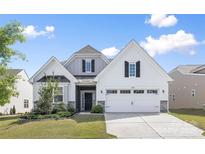 Beautiful home featuring a two-car garage and manicured landscaping at 14210 Asbury Park Rd, Huntersville, NC 28078