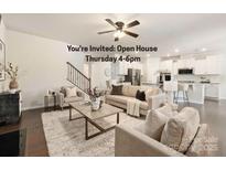 Inviting living room with hardwood floors, comfortable seating, and open floor plan into kitchen at 14210 Asbury Park Rd, Huntersville, NC 28078