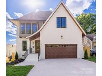 Stunning two-story home featuring a modern design, a two-car garage and a well manicured lawn at 1817 Union St, Charlotte, NC 28205