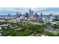 Stunning aerial view of Charlotte condo nestled among lush greenery with a beautiful city skyline backdrop at 526 N Davidson St, Charlotte, NC 28202