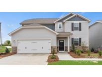 Charming two-story home with gray siding, stone accents, and a two-car garage at 566 Mountain View Dr, Monroe, NC 28110