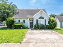 Charming single-story home with well-maintained lawn and manicured shrubbery at 6212 Derryfield Dr, Charlotte, NC 28213