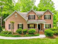 Beautiful brick two-story home featuring well-maintained landscaping and classic black shutters at 720 Kingsmill Ln, Clover, SC 29710