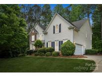 Charming two-story home featuring a manicured lawn, well-maintained landscaping and a two car garage at 109 Braxton Gate Ct, Mount Holly, NC 28120