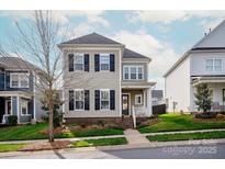 Charming two-story home features a well-maintained front yard and classic architectural details at 13818 Jacks Ln, Pineville, NC 28134