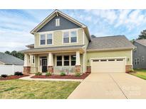 Charming two-story home with a welcoming front porch and well-maintained lawn at 16019 Kelby Cv, Charlotte, NC 28278