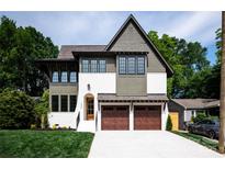 This is a charming two-story home with a two-car garage and a well-manicured front lawn at 1829 Union St, Charlotte, NC 28205