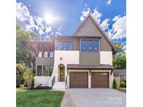 Inviting two-story home showcasing a manicured lawn, two-car garage and craftsman architectural details at 1829 Union St, Charlotte, NC 28205