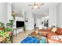 Open living room with hardwood floors, high ceilings, modern furniture, and lots of natural light at 2125 Southend Dr # 339, Charlotte, NC 28203