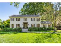 Charming two-story brick home with mature landscaping and a well-manicured lawn at 2501 Richardson Dr, Charlotte, NC 28211