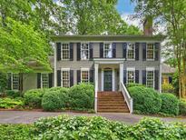 Charming two-story home with a brick stairway, complemented by lush landscaping and a welcoming facade at 3040 Valencia Ter, Charlotte, NC 28211