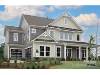 Beautiful two-story home showcasing a modern design and complemented by lush landscaping in a suburban neighborhood at 504 Meadow Ridge Dr, Belmont, NC 28012