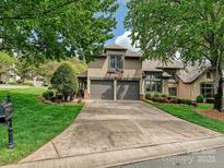 Charming two-story home with a large driveway and well-manicured landscaping at 5603 Ballinard Ln, Charlotte, NC 28277