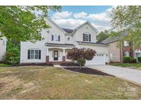 Charming two-story home with a well-manicured lawn and attached two car garage at 5745 Snapdragon Ln, Huntersville, NC 28078