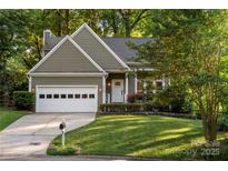 Charming home with a well-maintained lawn, two-car garage, and inviting front entrance at 9002 Maple Hill Ct, Huntersville, NC 28078