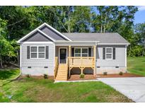 Charming one story home with a covered front porch, gray siding, black shutters, and green lawn at 951 Hardin Dr, Shelby, NC 28150