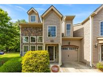 Charming townhome featuring stone accents, shingle siding, and an attached garage in a desirable neighborhood at 1161 Stuarts Landing Dr, Cramerton, NC 28032