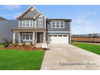 Two-story home showcasing a beautifully landscaped yard and a mix of siding and shingle exterior details at 1359 Russell St, Rock Hill, SC 29730