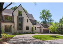 Stunning painted brick home showcasing a curved driveway and attached two car garage at 1719 Shoreham Dr, Charlotte, NC 28211