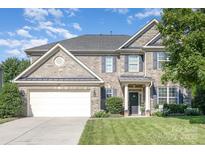 Charming two-story brick home with a well-manicured lawn and inviting entrance at 2467 Chatham Dr, Fort Mill, SC 29707