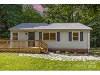 Charming home featuring a well-maintained yard, wooden deck, and stone pathway to the front door at 2603 Mary Ave, Gastonia, NC 28052
