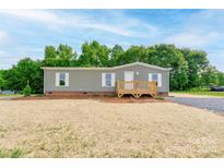 Charming single-story home with a inviting front porch and nicely maintained lawn at 445 Davis Rd, Shelby, NC 28152