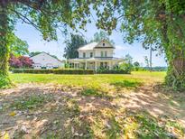 Charming two-story home with a metal roof and a spacious, covered front porch at 4815 Nc 109 Hwy, Wadesboro, NC 28170