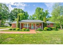 Charming brick home featuring a well-manicured lawn, tidy landscaping and a welcoming front porch at 539 30Th Nw Ave, Hickory, NC 28601