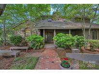 Charming stone facade home with a welcoming brick walkway and covered front entrance at 5915 Mammoth Rd, Charlotte, NC 28270