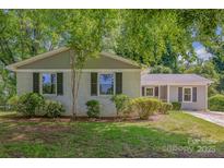 Charming single-story home featuring a freshly painted exterior, well-maintained landscaping, and inviting curb appeal at 6007 Charing Pl, Charlotte, NC 28211