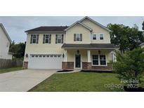 Charming two-story home featuring a well-maintained lawn and attached two-car garage at 7031 Woodbridge Valley Cir, Charlotte, NC 28227