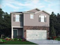 Two-story home with gray siding, brick accents, attached garage, and manicured front yard at 1326 31St St, Conover, NC 28613