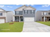 Two story home with blue siding, black shutters, and a well-manicured lawn at 134 Rustling Waters Dr, Mooresville, NC 28117