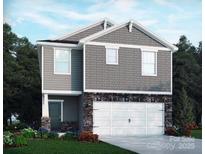 Charming two-story home boasts stone accents, gray siding, and a two-car garage, all in a well-manicured lawn at 1342 31St St, Conover, NC 28613