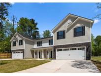 Charming new construction home with a stone base, siding exterior, and attached two-car garage at 1604 Breezewood Dr, Charlotte, NC 28262