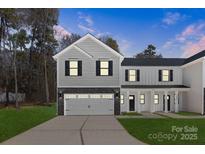 Two story home with a gray and white color scheme, black shutters, and a two car garage at 1604 Breezewood Dr, Charlotte, NC 28262