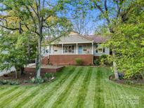 Charming home with a brick foundation, inviting front porch, and lush green lawn at 1631 Amanda Ln, Rock Hill, SC 29730