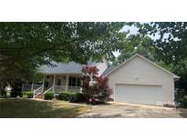 Charming home with a two-car garage and a cozy front porch nestled under mature trees at 165 Graceland Pl, Salisbury, NC 28146
