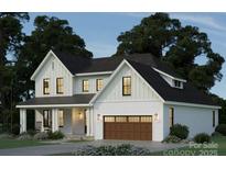 Stunning exterior elevation of a two-story home featuring a black roof and a two-car garage at 1807 Kennesaw Dr, Charlotte, NC 28216
