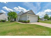 Charming single-story home with a well-manicured lawn, tidy landscaping, and a two-car garage at 23147 Whimbrel Cir, Fort Mill, SC 29707