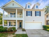 Charming two-story home features a covered porch, second-story balcony, and attached garage at 3510 Heathcott Cir, Charlotte, NC 28262
