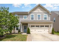 Charming two-story home featuring a two-car garage and a welcoming blue front door at 3618 Catherine Creek Pl, Davidson, NC 28036