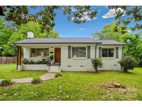 Charming brick home with green shutters, beautiful landscaping, and a well-maintained front yard at 4021 Paisley Pl, Charlotte, NC 28208