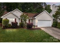 Charming one-story home boasts manicured lawn, fresh landscaping, and a two-car garage at 508 Long Creek Pkwy, Charlotte, NC 28214