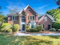 Traditional brick home with symmetrical design, manicured landscaping, and inviting entrance at 628 Highland Ridge Rd, Mooresville, NC 28115