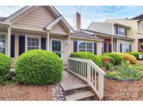 Charming home featuring manicured landscaping, a quaint walkway, and a welcoming entrance at 9232 Four Mile Creek Rd, Charlotte, NC 28277