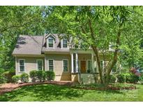Charming home with a classic design, featuring a covered front porch and mature trees providing shade at 9526 Greyson Ridge Dr, Charlotte, NC 28277