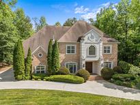 Stunning two-story brick home with manicured landscaping and a circular driveway, exuding curb appeal at 1009 Seminole Dr, Waxhaw, NC 28173