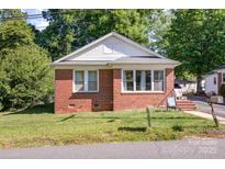 Charming single-story brick home with a well-maintained lawn and inviting curb appeal at 124 10Th Sw St, Conover, NC 28613