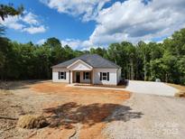 Charming one-story home with a well-maintained front yard and a driveway, set against a lush, green backdrop at 1247 Beltline Rd # 1, Chester, SC 29706